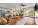 Inviting living room featuring a comfortable sectional sofa and a seamless transition to the kitchen area at 6813 W Yale Ave, Lakewood, CO 80227
