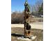 Tall sculpture of a wolf above a bear cub, part of community park art at 7207 Dolores Ave, Frederick, CO 80530