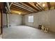 Unfinished basement with exposed ceiling, concrete walls, and a small window for natural light at 8251 W 54Th Ave # 4, Arvada, CO 80002