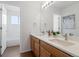 Bright bathroom features a double sink vanity with quartz countertop and framed mirror at 8251 W 54Th Ave # 4, Arvada, CO 80002