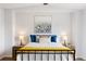 Bright bedroom featuring a black metal bed frame adorned with colorful pillows and a vibrant yellow throw blanket at 8251 W 54Th Ave # 4, Arvada, CO 80002