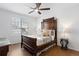 Charming bedroom with hardwood flooring, a decorative dark wood bed, and natural light at 8251 W 54Th Ave # 4, Arvada, CO 80002