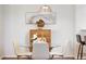 Cozy dining area with modern decor, featuring a stylish glass table and a decorative wall hanging at 8251 W 54Th Ave # 4, Arvada, CO 80002