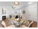 Open-concept dining area with modern lighting and sleek glass-top table at 8251 W 54Th Ave # 4, Arvada, CO 80002