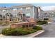 Attractive townhouse complex with brick accents, manicured landscaping, and community signage at 8251 W 54Th Ave # 4, Arvada, CO 80002