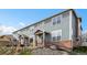 Charming townhouse with gray siding, brick accents, and a cozy covered entry at 8251 W 54Th Ave # 4, Arvada, CO 80002
