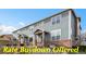 Charming townhome featuring blue siding, brick accents, and well-maintained landscaping at 8251 W 54Th Ave # 4, Arvada, CO 80002
