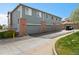 Exterior view of the building showing private garages and brick columns adding curb appeal at 8251 W 54Th Ave # 4, Arvada, CO 80002