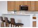 A sleek breakfast bar with modern stools complements the updated kitchen at 8251 W 54Th Ave # 4, Arvada, CO 80002