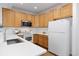 Bright kitchen with stainless steel appliances, white countertops, and wooden cabinets at 8251 W 54Th Ave # 4, Arvada, CO 80002