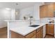 Well-lit kitchen features white countertops, wood cabinets, and stainless steel faucet at 8251 W 54Th Ave # 4, Arvada, CO 80002