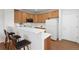 Well-lit kitchen with breakfast bar, light wood cabinetry, and modern appliances at 8251 W 54Th Ave # 4, Arvada, CO 80002