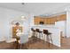 Bright kitchen and dining area with wood cabinets, a bar, and modern lighting fixtures at 8251 W 54Th Ave # 4, Arvada, CO 80002