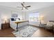 Bright main bedroom with a large window, ceiling fan, and decorative rug at 8251 W 54Th Ave # 4, Arvada, CO 80002