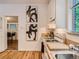 White kitchen with wood floors, stove, and view into dining area at 2303 - 2305 W 32Nd Ave, Denver, CO 80211