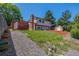 Large backyard featuring lush green grass, a storage shed, and a covered pergola at 18083 E Atlantic Dr, Aurora, CO 80013