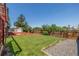 Spacious backyard with well-maintained lawn, storage shed, wood fencing, and gravel at 18083 E Atlantic Dr, Aurora, CO 80013