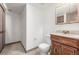 Bathroom featuring a wood vanity, tiled floors, toilet and storage at 18083 E Atlantic Dr, Aurora, CO 80013