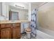 Cozy bathroom featuring a vanity, toilet, and shower with blue patterned curtain at 18083 E Atlantic Dr, Aurora, CO 80013