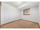 Bright and neutral bedroom featuring neutral carpet, trim, and a window at 18083 E Atlantic Dr, Aurora, CO 80013