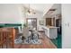 Bright dining area with modern chandelier and convenient access to the adjacent kitchen at 18083 E Atlantic Dr, Aurora, CO 80013