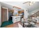 Open-concept kitchen and dining area featuring an island with seating and adjacent living area at 18083 E Atlantic Dr, Aurora, CO 80013