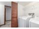 Laundry room featuring washer and dryer, a folding door, and wire shelving at 18083 E Atlantic Dr, Aurora, CO 80013