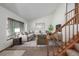 Bright living room featuring vaulted ceilings, a large window, and staircase with wooden banister at 18083 E Atlantic Dr, Aurora, CO 80013