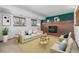 Inviting living room with cozy brick fireplace, neutral decor, and bright natural light from two large windows at 18083 E Atlantic Dr, Aurora, CO 80013