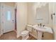 Cozy bathroom with pedestal sink and tile flooring, adjacent to a shower enclosure at 575 Howling Cir, Elizabeth, CO 80107