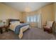 Inviting bedroom featuring a large bed, chandelier lighting and bright windows at 575 Howling Cir, Elizabeth, CO 80107