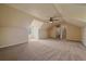 Expansive bonus room with neutral carpet, ceiling fan, and attached bathroom at 575 Howling Cir, Elizabeth, CO 80107