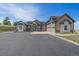 Charming exterior elevation with stone accents, three-car garage and long driveway at 575 Howling Cir, Elizabeth, CO 80107