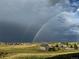 Scenic view of a neighborhood featuring a double rainbow across the sky after a storm at 575 Howling Cir, Elizabeth, CO 80107