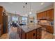 Gourmet kitchen with granite counters, an island and stainless steel appliances overlooking the living room at 575 Howling Cir, Elizabeth, CO 80107