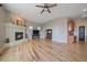 Bright living room featuring a tile fireplace, hardwood floors and lots of windows at 575 Howling Cir, Elizabeth, CO 80107