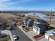 Aerial view of homes with well-maintained lawns, water views, and solar panels at 5895 E Conservation Dr, Frederick, CO 80504