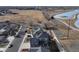 Scenic aerial view of homes with solar panels, nestled near a serene lake and open land at 5895 E Conservation Dr, Frederick, CO 80504