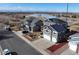 Aerial view of homes with well-maintained lawns, water views, and solar panels at 5895 E Conservation Dr, Frederick, CO 80504