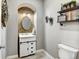 Charming powder room with stylish decor, wood wall accents, and modern fixtures at 5895 E Conservation Dr, Frederick, CO 80504