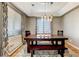 Bright dining room with a long wooden table, bench seating, and modern light fixture at 5895 E Conservation Dr, Frederick, CO 80504