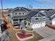 Beautiful two-story home with a manicured lawn, landscaped beds, porch, and solar panels on the roof at 5895 E Conservation Dr, Frederick, CO 80504