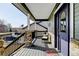 Covered front porch featuring stone pillars, furniture, and a welcome mat at 5895 E Conservation Dr, Frederick, CO 80504