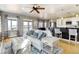 Open concept living room with view of the kitchen and dining area, and bright natural light at 5895 E Conservation Dr, Frederick, CO 80504