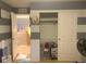 Bedroom featuring striped walls, closet and adjacent room views at 23465 E Platte Dr # C, Aurora, CO 80016