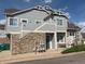 Side exterior view of townhome featuring blue siding and convenient gas meter access at 23465 E Platte Dr # C, Aurora, CO 80016