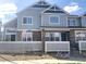 Charming townhome showcasing blue siding, stone accents, and well-maintained landscaping at 23465 E Platte Dr # C, Aurora, CO 80016