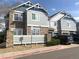 Well-maintained townhome showcasing blue siding, stone accents, and ample parking at 23465 E Platte Dr # C, Aurora, CO 80016