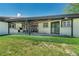 Back patio with outdoor kitchen, seating and manicured lawn at 6220 E 5Th Ave, Denver, CO 80220