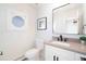 Stylish powder room with modern fixtures, a decorative mirror, and elegant design elements at 6220 E 5Th Ave, Denver, CO 80220